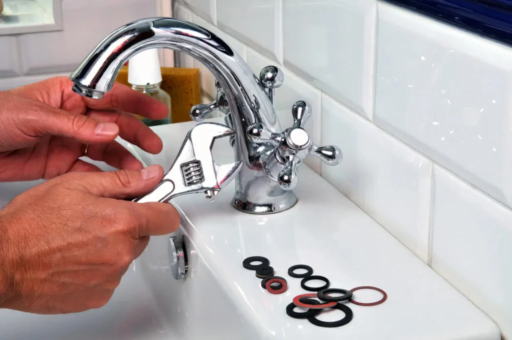 Plumber performing maintenance on a bathroom faucet in Davenport