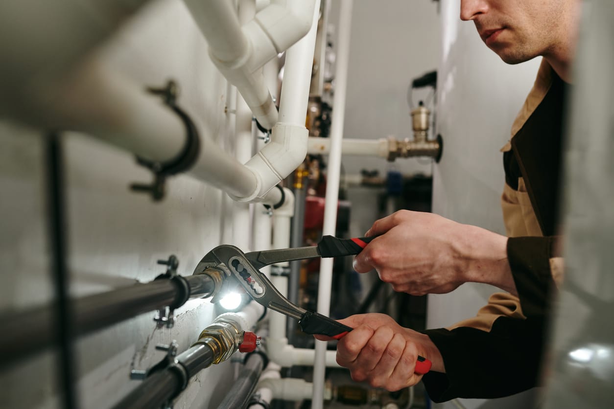 Plumbers maintaining commercial plumbing pipes in Davenport