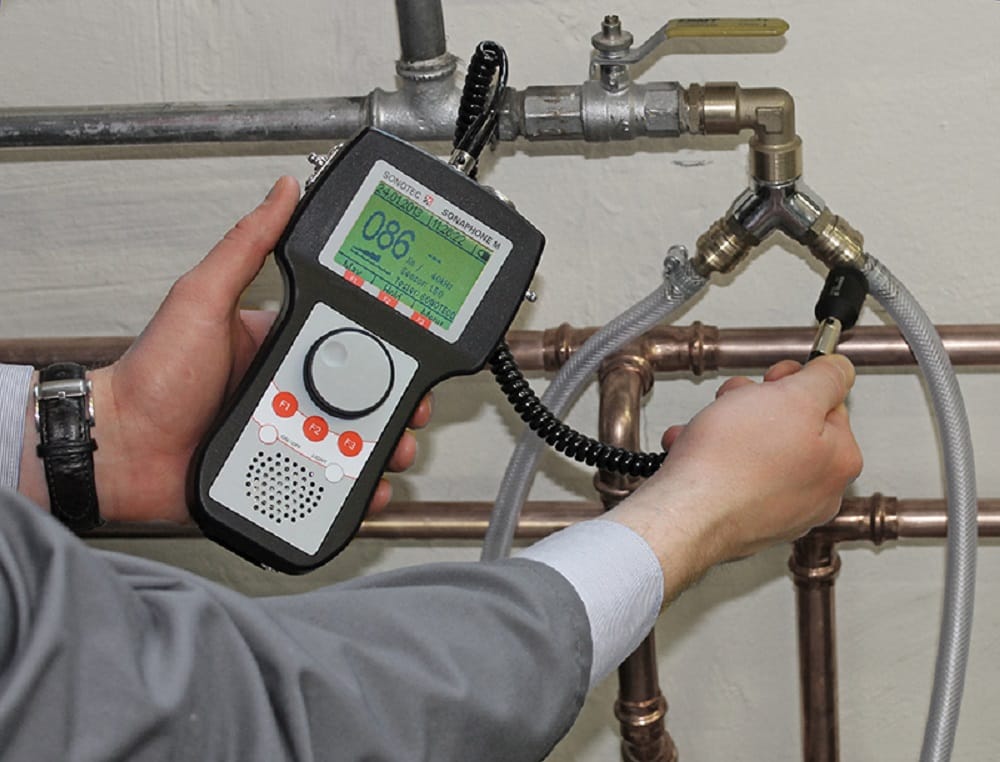 Plumber testing pipes with electronic leak detection equipment in Davenport