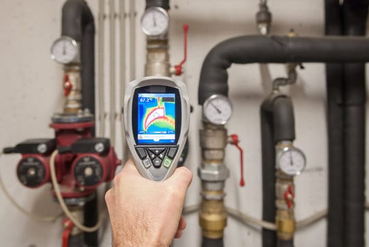 Plumber using a thermal imaging camera to inspect pipes in Davenport