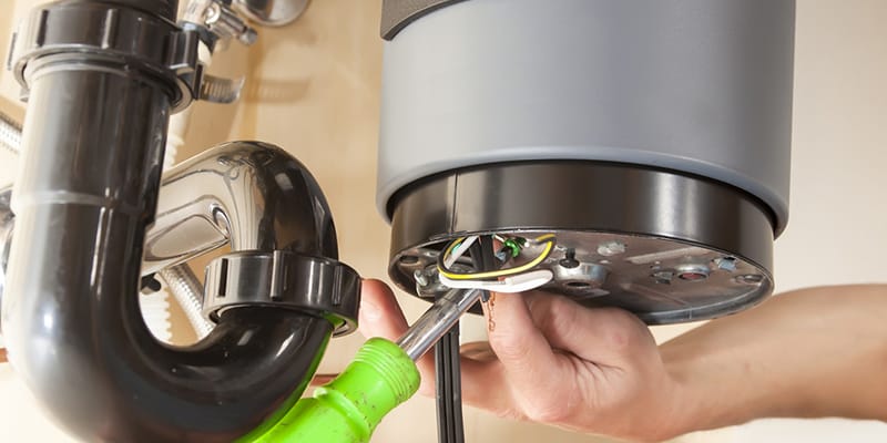Technician repairing the heating element of a water heater in Davenport